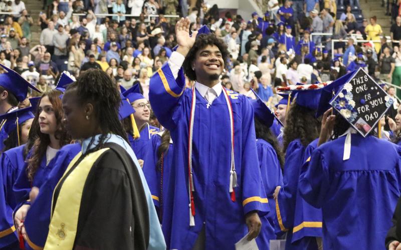 Graduating senior Marcus Rivera smiles and waves to his family during the Friday, May 22, Copperas Cove High School graduation ceremony.