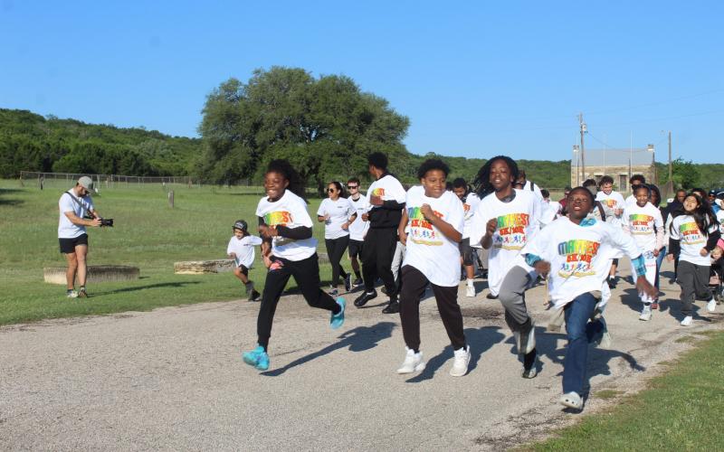 Runners take off at the start of Saturday's Mayfest 5K fun run.
