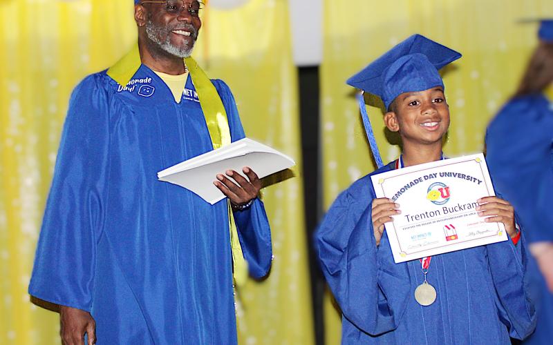 Fairview/Miss Jewell Elementary fourth grader Trenton Buckram, 10, receives his Lemonade Day University graduation certificate from Central Texas College Net Impact member Donald Sturkey, marking the completion of a hands-on entrepreneurship experience.