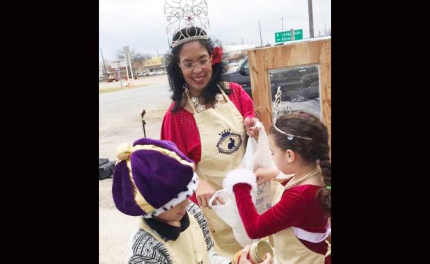 Rabbit Fest Ambassador Edith Natividad, Junior Miss Rabbit Fest Kaydence Weary, and Junior Mister Rabbit Fest Keli’l Natividad place non-perishable items in the Blessing Box. Edith Natividad built and erected the outdoor pantry which allows donations to be received 24 hours a day and for those who are hungry to receive food when the soup kitchen is closed.
