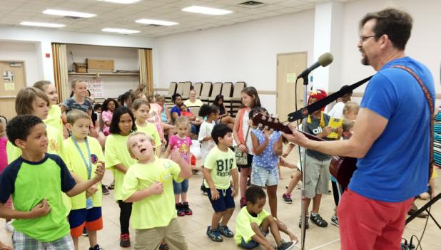 CCLP/DAVID J. HARDIN - Children’s singer/songwriter Joe McDermott performs for local children at the Copperas Cove Public Library on Thursday as part of the library’s summer reading program.