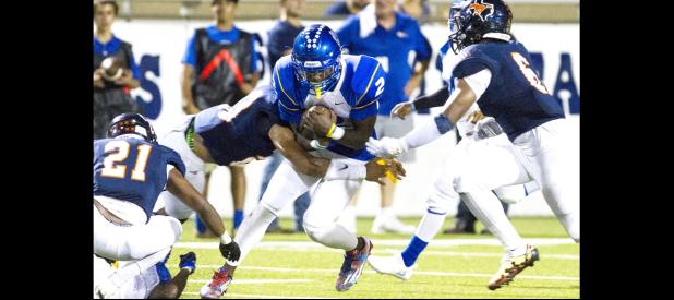 CCLP/STEVEN DOLL - Copperas Cove senior quarterback Caine Garner gets trapped between Sachse defenders Micah Buchanan, Isaiah Humphries and Cedric Johnson during the second quarter of Friday evening’s game at Homer B Johnson Stadium in Garland.