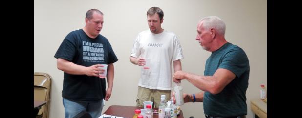 CCLP/DAVID J. HARDIN - Derek Chase, Matthew Shelley, and Stephen Bennett sample almonds and drink Bai antioxidant infusion drinks during the men’s health improvement class last Thursday night at GymKix.
