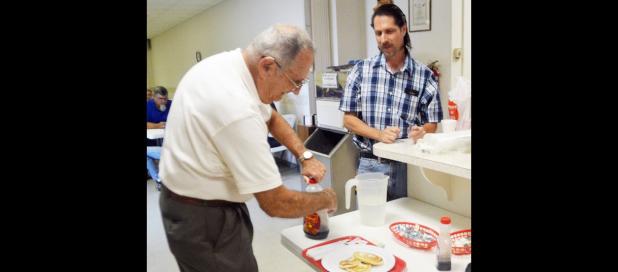 CCLP/LYNETTE SOWELL - John Moltz adds syrup to his pancakes during Saturday morning’s all-you-can-eat pancake breakfast held by the Mt. Hiram Masonic Lodge. The event served as a fundraiser for the lodge’s community service projects.