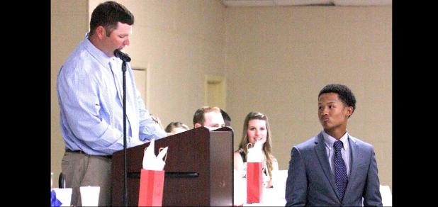 CCLP/TJ MAXWELL - Cove senior Tim Bechtold looks on as head baseball coach Dustty Brittain reads a laundry list of Bechtold’s accomplishments during the annual awards banquet at the Copperas Cove Civic Center on Thursday. Bechtold was named MVP for the second year.