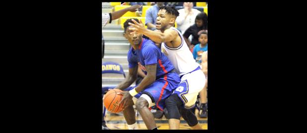 CCLP/TJ MAXWELL - Cove junior Dahmir Pearson defends against Midway senior Joe Ward in the first half of the Bulldawgs’ 53-50 win over the Panthers on Friday.