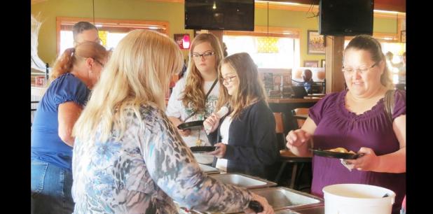 CCLP/DAVID J. HARDIN - Local residents get breakfast at Applebee’s during the Blue Santa pancake breakfast fundraiser held on Saturday.