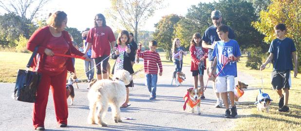 CCLP/BRITTANY FHOLER - The Gibson family and their five corgis interact with a dog dressed as Bill Clinton and his owner who was dressed as Hillary Clinton on the 1-mile route dog walk at the Howl O Ween Puppy Palooza held at Copperas Cove City Park Saturday morning.