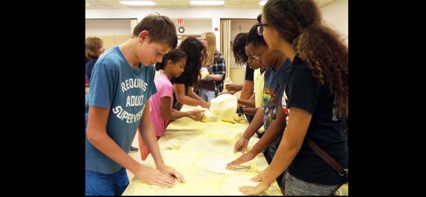 CCLP/PAMELA GRANT - Teenagers play with their own bits of dough at the dough show put on by Domino’s at the library. The dough show was the library’s reward to the teens at the end of the Summer Reading Program.