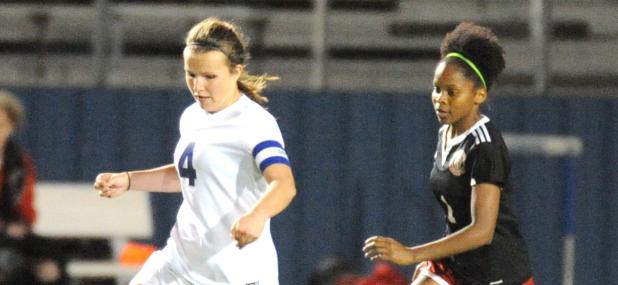 CCLP/LEE LETZER - Cove senior Ali McBride dribbles down field in front of Harker Heights defender Sierra Dickey during their District 12-6A contest Tuesday at Bulldawg Stadium. McBride scored Cove’s lone goal in the 1-0 shutout
