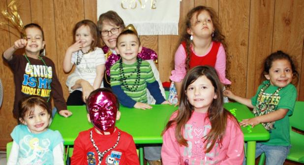 CCLP/KATHLEEN STARLING Reverend Paulette Magnuson with the smallest of her flock celebrate Shrove Tuesday with beads, masks and pancakes