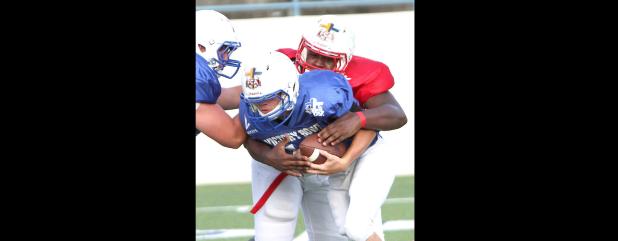 CCLP/TJ MAXWELL - Former Copperas Cove defensive lineman Martinez Rogers wraps up Blue Team quarterback Hunter Parrish of Goldthwaite during the eighth annual Fellowship of Christian Athletes Victory Bowl on Saturday. Rogers had four tackles and one sack for the Red Team in the 7-6 loss.