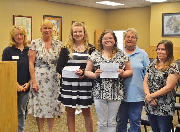 CCLP/LYNETTE SOWELL  Mikayla Miller and Delaney Brown receive $500 scholarship checks from Keep Copperas Cove Beautiful at Tuesday night's city council workshop.