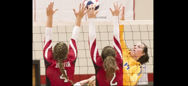 CCLP/TJ MAXWELL - Cove senior Brianna Acker hits into the defense of Belton seniors Chloe Bush (4) and Breanna Farrell during the Lady Dawgs’ 3-2 win over Belton on Friday. Cove is going to need Acker and the rest of the squad to play thir best game of the year in order to beat no. 1 state- and nationally-ranked Waco Midway.