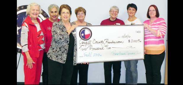 File Photo - Members of the Fort Hood Spouses Club present a check for $2,000 to the Coryell County Rainbow Room based in Copperas Cove. The facility provides clothing, shoes and more to children who have been removed from their home by Child Protective Services.