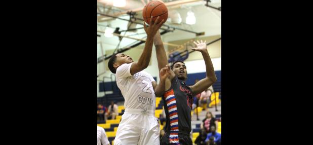 CCLP/TJ MAXWELL - Cove senior captain Dahmir Pearson shoots in front of San Angelo Central’s Hunter Gibbs in the third quarter of the Dawgs’ 72-62 win over the Bobcats Tuesday at Bulldawg Gymnasium. Pearson scored 14 points and had a game-high eight rebounds and four steals in the win.