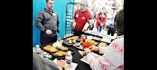 CCLP/LYNETTE SOWELL - Eric Smith, an H-E-B bakery partner, talks to military spouses about the artisan breads and other products available at the store’s bakery. H-E-B Plus! and the USO hosted spouses at an event on Wednesday which featured tips for shopping on a budget.