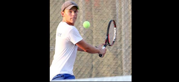 CCLP/TJ MAXWELL - Cove senior Brett Alber eyes the ball as he reaches for a backhand during district play. Alber and the Dawg Tennis team begin the playoffs Thursday in Waco.
