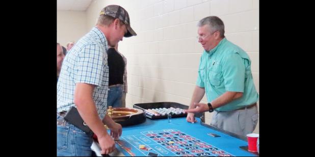 CCLP/BRITTANY FHLER - John Oster runs the roulette table at the Buyer’s Club Casino Night held Saturday night at the Copperas Cove Civic Center.