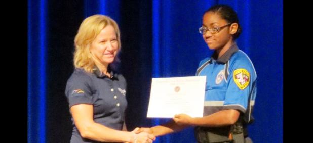 CCLP/BRITTANY FHOLER - Mekayla Tate accepts her award from city manager Andrea Gardner at the Law Enforcement Explorer Program Class of 2016 graduation held in Lea Ledger Auditorium Friday evening.