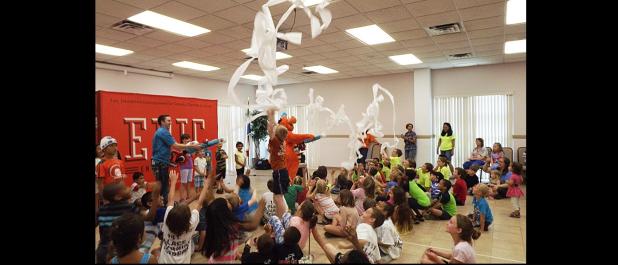 CCLP/PAMELA GRANT - Taylor Griswold, owner of Epic Entertainment, and Kazoo fired toilet paper into the audience as part of their show at the library’s Summer Reading Program.
