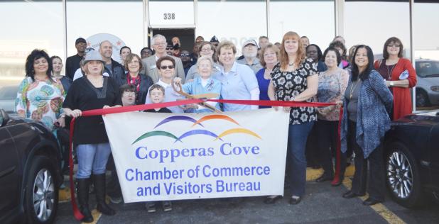 CCLP/LYNETTE SOWELL - Joann Courtland and Trudy Bolton with Operation Stand Down Central Texas cut the ribbon to the nonprofit’s newer, larger location in Cove Terrace Shopping Center on Saturday.