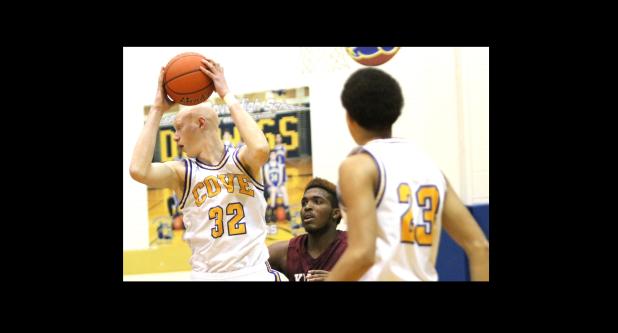 CCLP/TJ MAXWELL - Copperas Cove senior Wyatt Behara makes a move in the paint against Killeen senior Darius Moseley as senior Malyk Thomas looks on during the Bulldawgs’ 105-64 win over the Kangaroos on Friday.