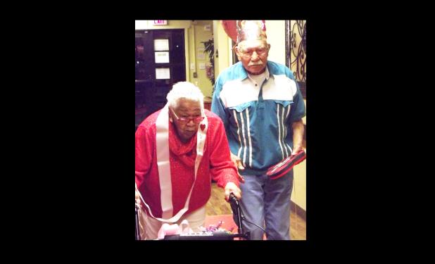 CCLP/PAMELA GRANT - After being crowned and sashed, Valentine’s Day king and queen of the nursing home, Beatrice Freeman and Frank Huereque make their way down the red ‘carpet’.