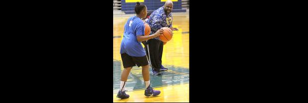 COURTESY PHOTO - Copperas Cove junior varsity coach Mike Anderson, right, puts campers through dribbling drills during the four-day Lady Dawgs basketball camp held last week at Bulldawg Gymnasium