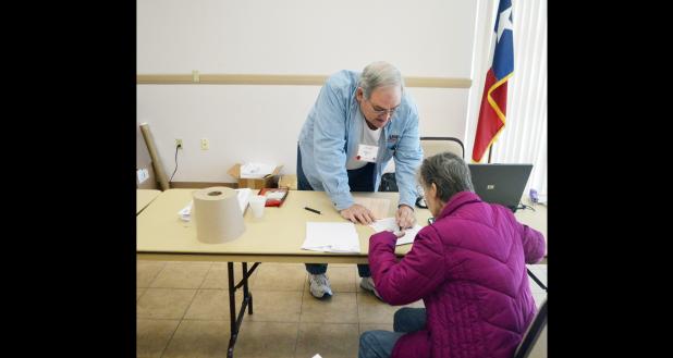 File Photo - An IRS-certified tax aide with AARP helps a client last year with their taxes at the Copperas Cove Public Library. The AARP volunteers returned this year to help residents with tax filing each Wednesday between now and the April 18.