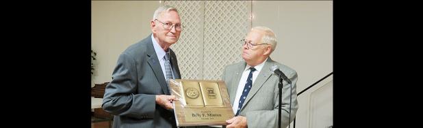 CCLP/DAVID J. HARDIN - Billy F. Minton receives the Noon Exchange Club Book of Golden Deeds Award from President-Elect Mike Blount. The banquet was held Saturday night at the Holy Family Catholic Church Social Hall.