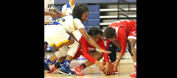 Courtesy photo - Cove’s Oni Boodoo, left, fights for a loose ball during the Lady Dawgs 66-55 win over Crosby as part of the 2016 Aggieland Invitational Tournament. The Lady Dawgs finished fourth out of 30 teams in the field with a 3-2 tournament record.