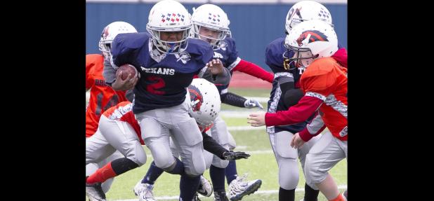 CCLP/TJ MAXWELL - Texans running back Josiah Wilson splits some Broncos defenders in the fourth quater of their 22-12 win in the Copperas Cove Youth Football League Division I championship held Saturday at Bulldawg Stadium. Wilson scored on touchdown runs of 68, two and six yards.