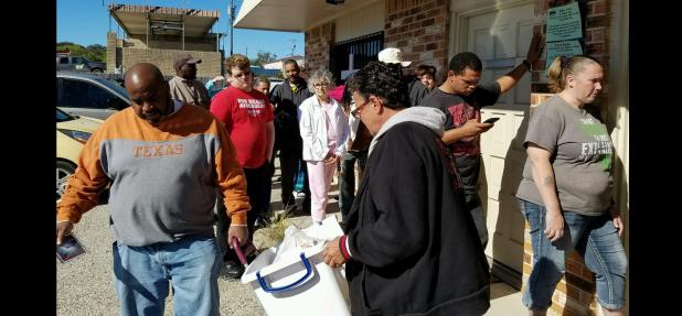 Courtesy Photo - Residents lined up around the Mission Casa building on Saturday morning as the church distributed 50 Thanksgiving baskets, along with regular items from its food pantry.