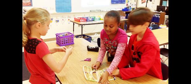 COURTESY PHOTO - Clements/Parsons Elementary gifted education students Emily Kimball, Brenda Thomas and Joy Trump build a bone bridge through a STEM challenge. The purpose was to have students apply the rigor of science, technology, engineering, and mathematics content to the challenge and come up with solutions.