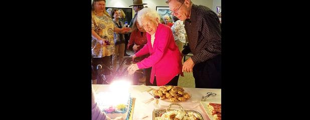 CCLP/PAMELA GRANT - Surrounded by friends and family, Cove’s oldest living resident, Edna Teinert, pre-pares to blow out the candles on her 106th birthday cake.