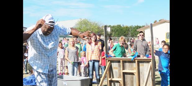 CCLP/BRITTANY FHOLER - Kids lined up to throw water balloons at Michael Anderson, Campus Director of Cove Charter Academy, at the annual Fall Extravaganza held Friday afternoon.