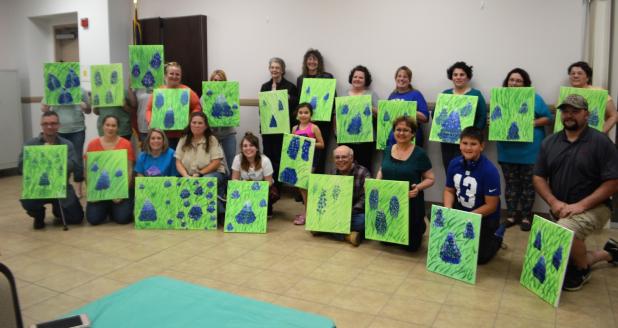 CCLP/LYNETTE SOWELL - Participants in Friday night’s painting fundraiser, “Painting With Brittany”, show off their work at the end of the night. The event was held by the Five Hills 4-H Club at the Copperas Cove Public Library to help with the club’s community service projects.
