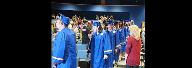 CCLP/DAVID J. HARDIN - Crossroads High School graduates walk into the Lea Ledger Auditorium during last Thursday’s Fall 2016 commencement ceremony. 25 students re-ceived their diplomas.
