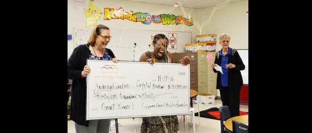 CCLP/BRITTANY FHOLER - Andrea Cardon and Crystal Buckram get sprayed with silly string as they hold the check for their $3,130 grant at J.L. Williams/Lovett Ledger Elementary Thursday morning.