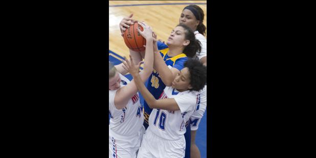 CCLP/TJ MAXWELL - Cove senior Dejhana Butler fights for a rebound in a crowd of Midway defenders during their 60-44 loss Tuesday in Waco. The Lady Dawgs return to action tonight at home against San Angelo Central.