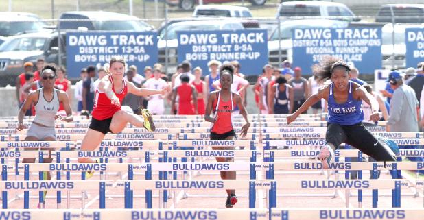 CCLP/TJ MAXWELL - Cove sophomore Mahal Thorpe leads her heat of the 100-meter hurdles during the the Bulldawg Relays held Saturday at Bulldawg Stadium. Thorpe finished second overall with a time of 15.86 seconds.