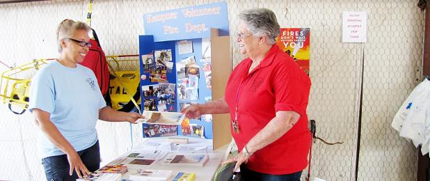 CCLP/PAMELA GRANT - Nancy Owen hands out a fire safety pamphlet during the Kempner Volunteer Fire Department’s open house.