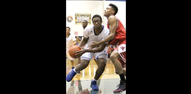 CCLP/TJ MAXWELL - Copperas Cove junior Daveon Thomas drives the lane past Harker Heights junior Rhandy Hughes for two of his team-high 16 points during the Dawgs’ 57-56 loss the the Knights on Friday. Thomas scored eight of his 16 points in the fourth quarter. Hughes’ only basket on the night cam on a lastminute tip-in to secure the Knights’ win.