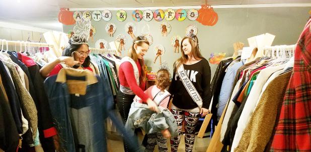 CCLP/PAMELA GRANT - Members of the Rabbit Fest Royalty helped sort through coats and jackets that were given away at the Trinity Worship Center’s Coats for the Cold event