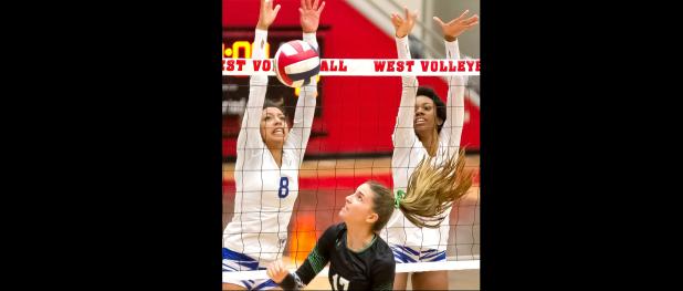 CCLP/TJ MAXWELL - Cove sophomore Aidan Chace (8) and senior Zari Chipman, defend against Southlake Carroll senior Haley Hallgren during the Area round of the 2016-17 UIL State Volleyball Playoffs.