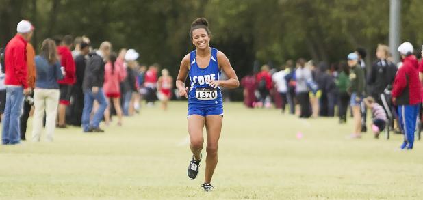 CCLP/TJ MAXWELL - Cove senior Amber Boyd grimaces as she finishes the District 8-6A meet in second place Thursday at the Heart Of Texas Soccer Complex in Waco. Boyd lead her team to a second-place finish as well and Region I-6A qualification.