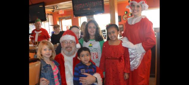 CCLP/LYNETTE SOWELL - Jessica Centunzi-Sanchez, as Mrs. Claus, and Phillip Imergoot, as Santa Claus, pose with kids at Saturday morning’s pancake breakfast fundraiser for Relay For Life Lampasas-Copperas Cove at Applebees. Sanchez is the event team leader for Lampasas, and Imergoot is part of the Copperas Cove event team.