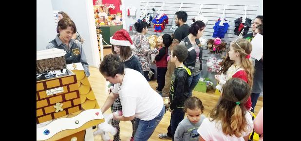 CCLP/DAVID MORRIS - B.J. Calloway fills a unicorn with stuf fing as she helps an exceptional needs student from Copperas Cove ISD during the holiday bear party hosted by the Moose Riders and Bearables in Copperas Cove.