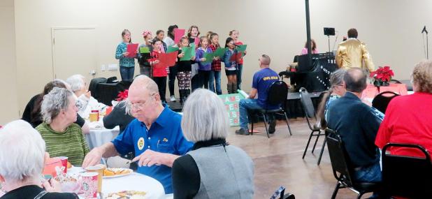 CCLP/BRITTANY FHOLER - Senior citizens of Copperas Cove eat and enjoy entertainment by the Sunrise Singers from Williams-Ledger Elementary School at the annual Christmas senior dinner hosted by the Copperas Cove Exchange Club at the Copperas Cove Civic Center Sunday afternoon.